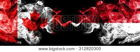 Canada Vs Monaco, Monacan Smoky Mystic Flags Placed Side By Side. Thick Colored Silky Smoke Flags Of