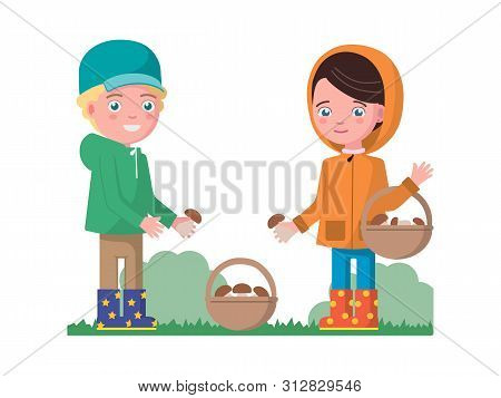 Boy And A Girl In Autumn Clothes With A Raincoat Jacket Gathering Mushrooms In A Basket. Children In