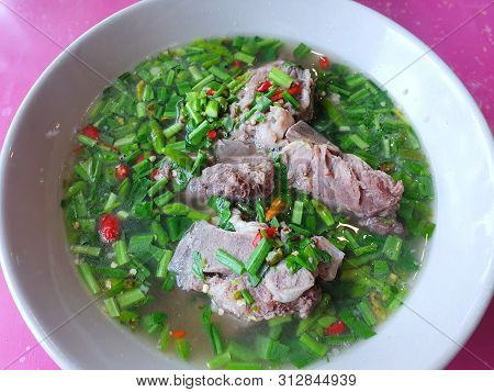 Thai Food Style, Selective Focus Of Hot And Spicy Pork Neck Bones Soup In White Bowl As A Background