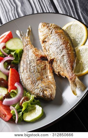 Delicious Fried Salpa Fish With Fresh Vegetable Salad Close-up On A Plate.  Vertical