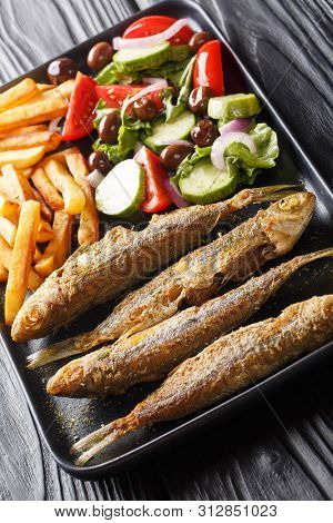 Fried Mediterranean Boops Boops Fish Served With Fresh Salad And French Fries Close-up On A Plate. V