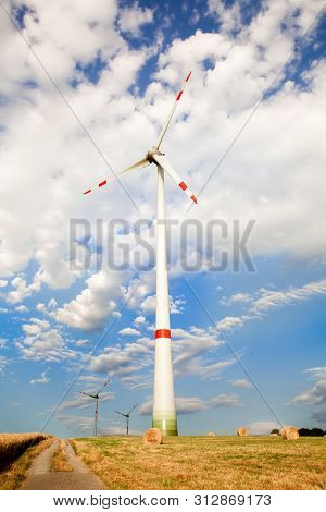 Windmills For Electric Power Production On The Field Of Cereal.