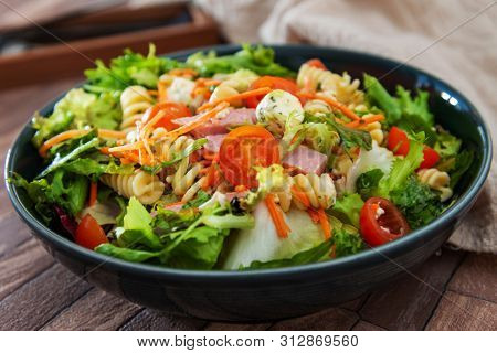 Salad made from radiatori cooked pasta, goat cheese and oil vinaigrette