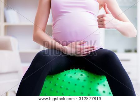 Pregnant woman exercising in anticipation of child birth