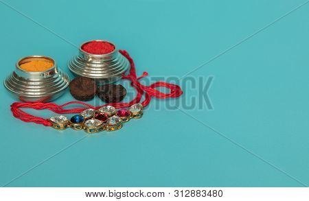 Raksha Bandhan Raakhi Or Rakhi With Kumkum On Blue Background.