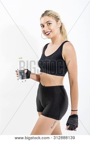 Woman After Sport Drinking Water From Bottle
