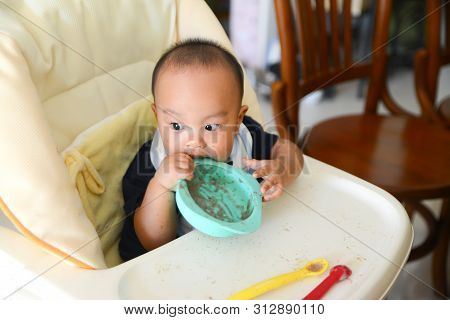 Asian Baby Boy 6 Months Old Eating By Himself With Baby Led Weaning (blw)method, Self-feeding