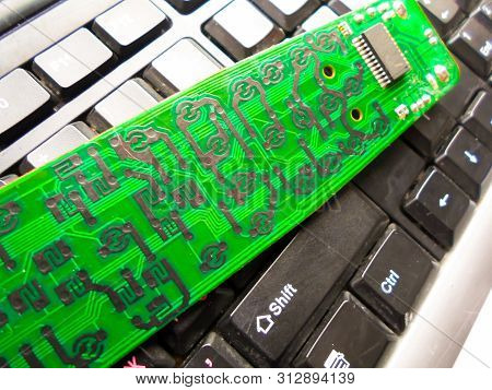 Green Electronic Board On The Keyboard. Repair Of Equipment. System Administrator.