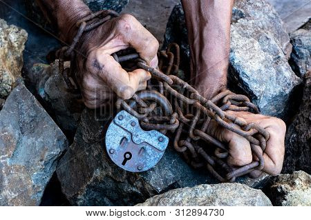 The Hands Of A Slave In An Attempt To Release. The Symbol Of Slave Labor. Hands In Chains.
