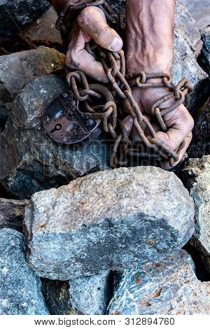 The Hands Of A Slave In An Attempt To Release. The Symbol Of Slave Labor. Hands In Chains.