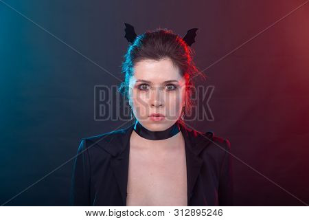 Halloween, Holidays And Carnival Concept - Vamp Woman In Jacket And With Bat Ears In Gothic Style.