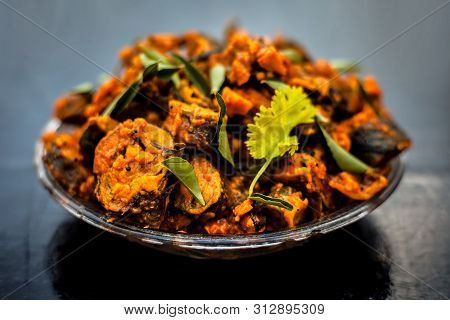 Famous Indian & Gujarati Snack Dish In A Glass Plate On Wooden Surface I.e. Patra Or Paatra Consisti