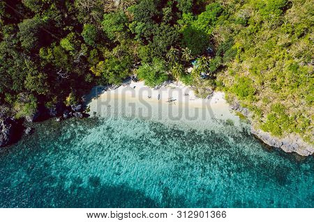 Top Down View Of Tropical Beach With Turquoise Water And White Sand