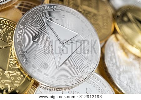 Tron Physical Coin On The Stack Of Other Different Cryptocurrencies. Tron Cryptocurrency Coin With B