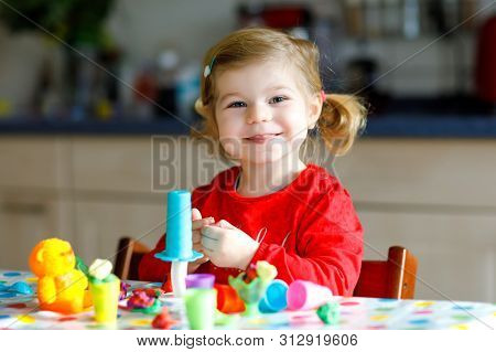 Adorable Cute Little Toddler Girl With Colorful Clay. Healthy Baby Child Playing And Creating Toys F
