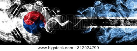 South Korea Vs Botswana, Botswanan Smoky Mystic Flags Placed Side By Side. Thick Colored Silky Abstr