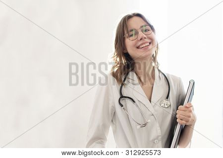 Portrait Of A Young Beautiful Nurse, Medical University Student Girl Is Standing With A Phonendoscop