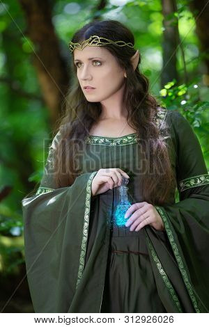 Elf With A Bottle Of Magic Potion In The Forest