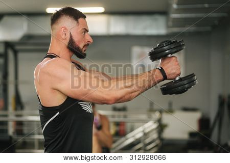 Bearden Bodybuilder In The Gym. Strong Man In Black T-shirt
