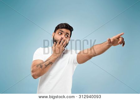 Half-length Close Up Portrait Of Young Hindoo Man In White Shirt On Blue Background. Human Emotions,
