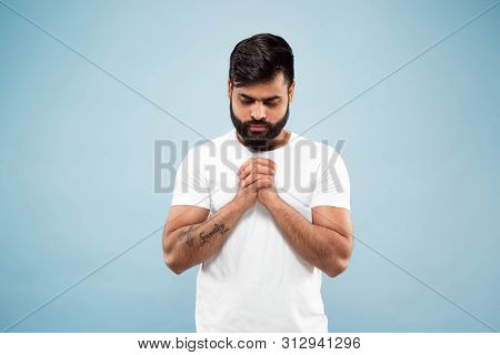 Half-length Close Up Portrait Of Young Hindoo Man In White Shirt Isolated On Blue Background. Human 