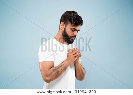 Half-length Close Up Portrait Of Young Hindoo Man In White Shirt Isolated On Blue Background. Human 