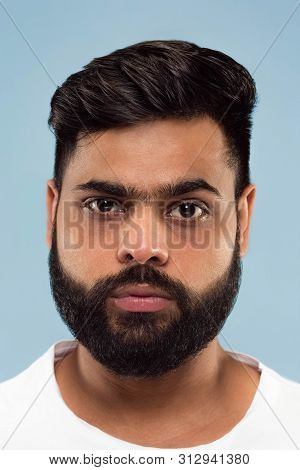 Close Up Portrait Of Young Hindoo Man With Beard In White Shirt Isolated On Blue Background. Human E