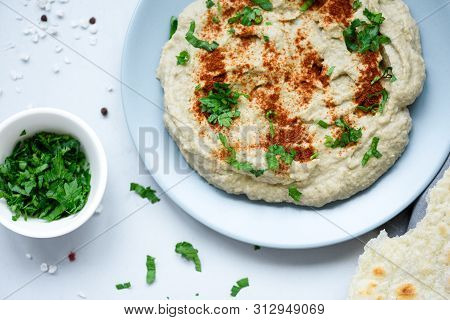 Eggplant Dip Baba Ganoush (mutabbal) With Herbs And Paprika On Gray Wooden Background. Selective Foc