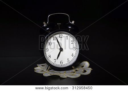 Classic Mechanical Alarm Clock On Dark Background. Low Key
