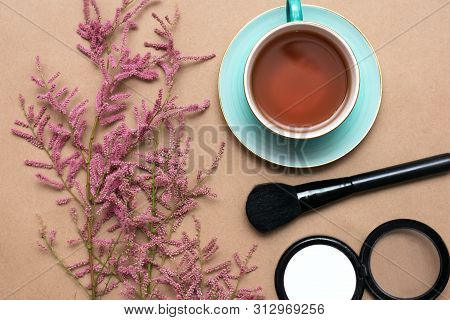 Make Up Concept Flat Lay Background. Make Up Brushes And Cosmetics, Cup Of Tea And A Blooming Tamari