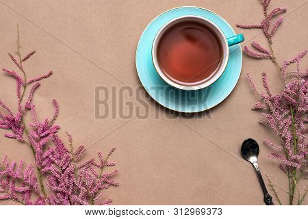 Cup Of Hot Tea And A Tamarix Gallica Tree Branches On A Brown Background.