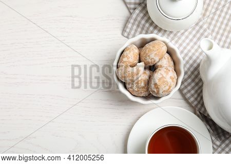 Tasty Homemade Gingerbread Cookies And Tea On White Wooden Table, Flat Lay. Space For Text