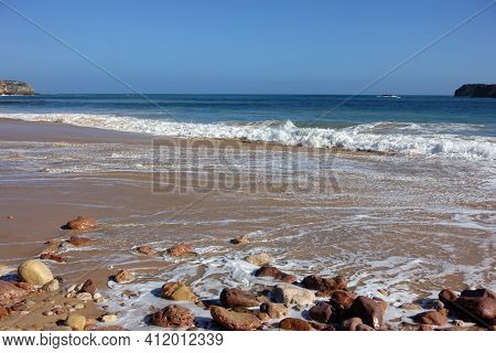 Beautiful Portuguese Beach With Sand, Rocks And Waves