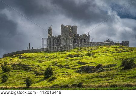 Majestic Castle, Rock Of Cashel, With Flying Crows Around The Tower And Dramatic Dark Storm Clouds I