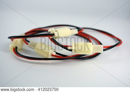 Large Electric Red Black Wires On 12v, 220v With White Plastic Dad Connector And Mom Located On A Wh