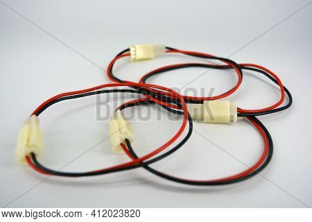 Large Electric Red Black Wires On 12v, 220v With White Plastic Dad Connector And Mom Located On A Wh