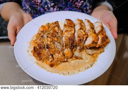 Large Pieces Of Beef On A Plate. Lean Meat In Its Own Juice. The Girl Serves A Dish Of Baked Beef. I