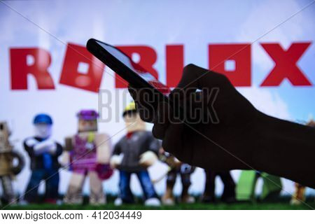 London, Uk - March 2021: Person Holding A Smartphone With Roblox Game Logo