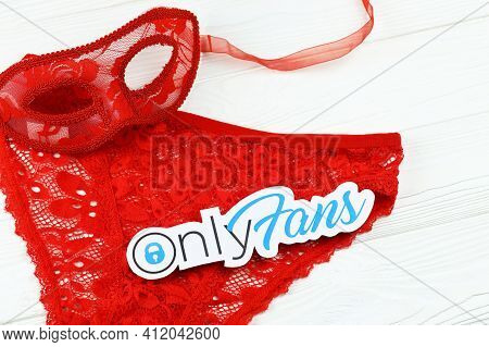 Kharkov, Ukraine - February 14, 2021: Onlyfans Paper Logo And Red Lingerie. Onlyfans Is Content Subs