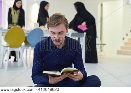Young muslim man reading Quran during Ramadan