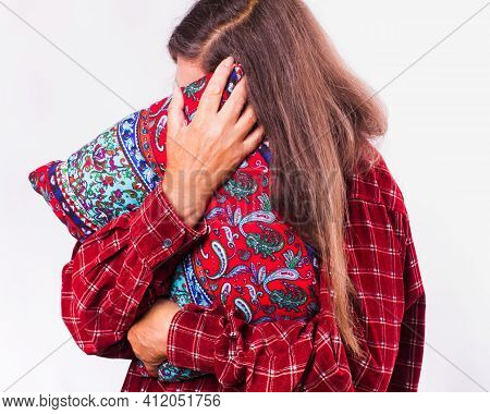 Mature Woman With Long Gray Hair Hugs A Pillow, Closed Face