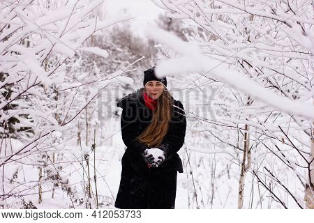 Beautiful Sexy Girl Tosing Snow. Around The Trees In The Snow
