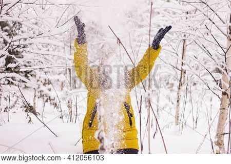 Beautiful Sexy Girl Tosing Snow. Around The Trees In The Snow
