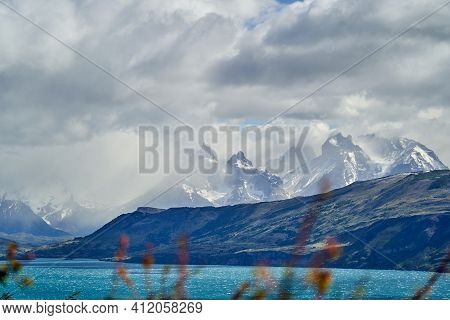 Horns Of Torres Del Paine Towering Over The Turquoise Water Of Lake Pehoe And A Mountain Ridge With 
