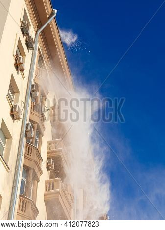 15.02.2021, Russia, Moscow. Utilities Of The City Clean The Roof Of A Multi-storey House From Snow.