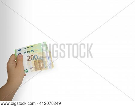 Closeup Outstretched Hand Holding Two,one Hundred Euro Bill Wad,white Background.payment,giving Mone