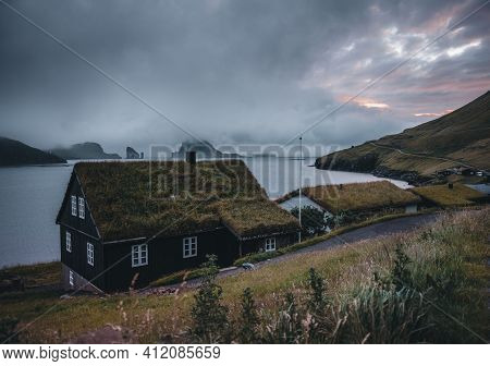 Bour Village Grass-covered Picturesque Houses At The Faroese Coastline In The Village Bour With View