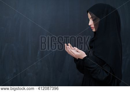Portrait of young Muslim woman making dua