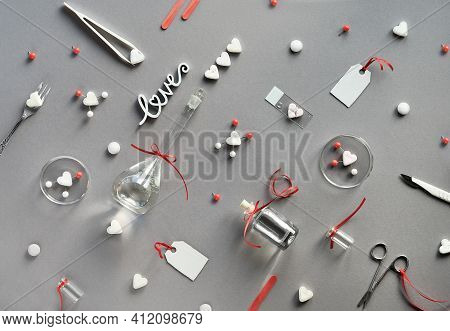 Chemistry Of Love. Creative Flat Lay On Grey Paper. Top View With Chemical Glassware, Petri Dishes, 