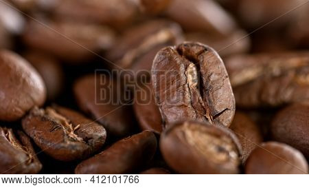Falling Roasted Coffee Beans, Macro Shot, close-up.